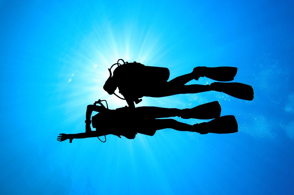 Two divers practicing underwater navigation.